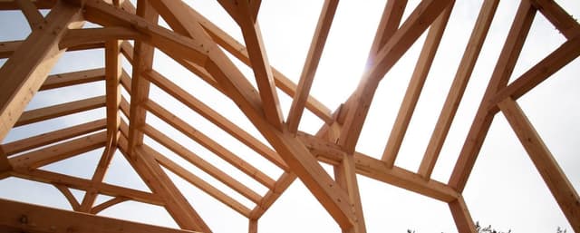 Timber frame great room with exposed trusses and valley joinery