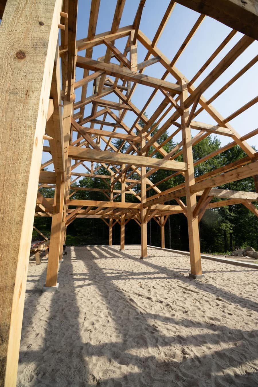 Traditional timber frame barn with purlins during raising