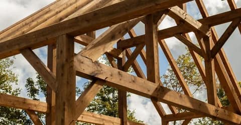 Custom timber frame great room with queens post trusses